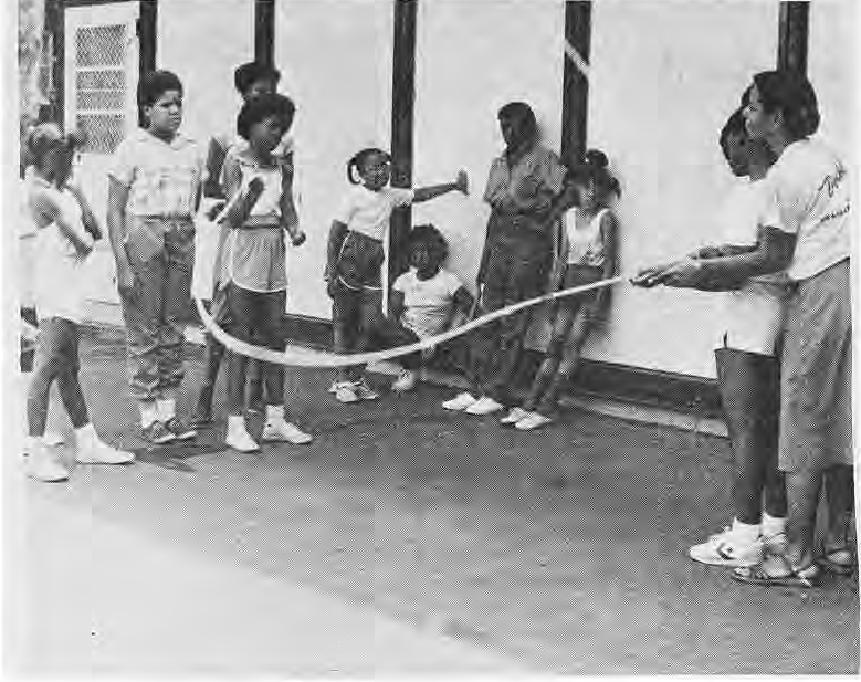 Children and Girl Scout Council instructor Yolanda Nolan-Flemons demonstrating double-dutch rope skipping at Hamilton School.