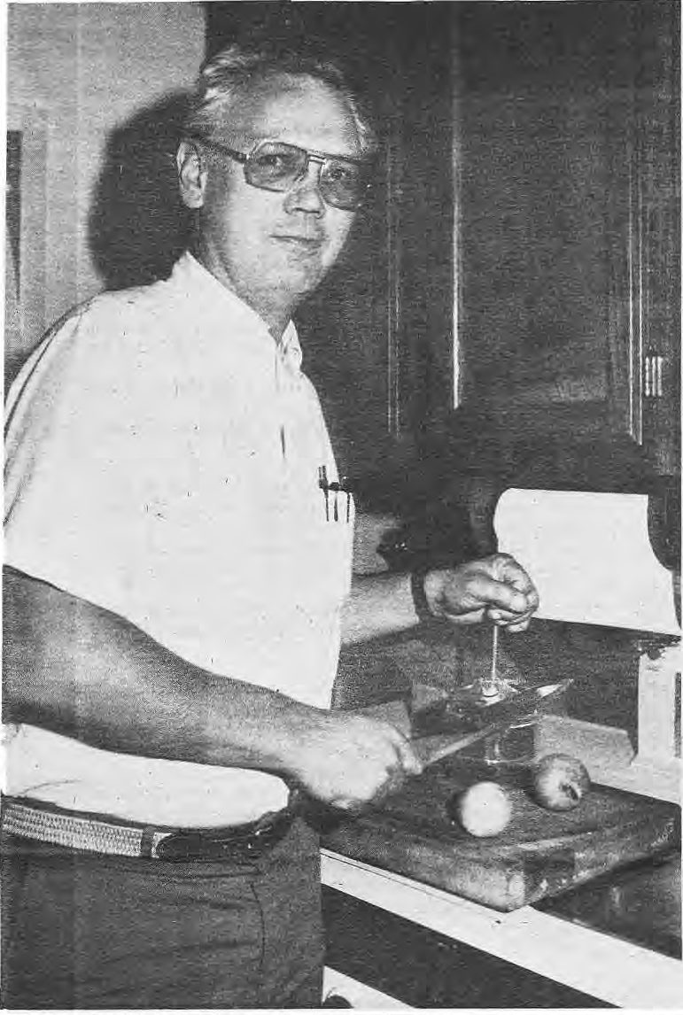Boulter Kelsey chopping vegetables in his kitchen.