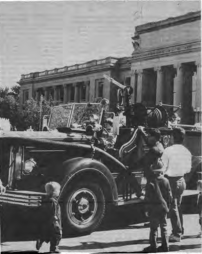 Visitors beside a vintage Mack fire truck at the History Museum.