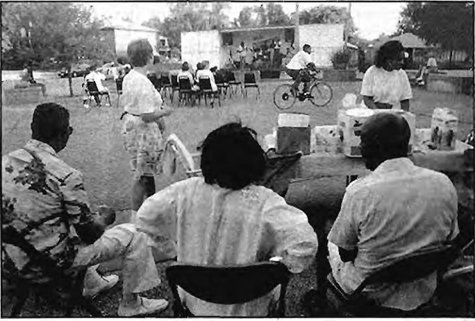 Tuesday,August6was National Night Out and the SDCC sponsored a neighborhood party.In the foreground Gwen Lazard helps the5900McPherson block unit sell ice cream to the crowd while in the background neighbors listen to music from a portable stage. Photographer not credited.