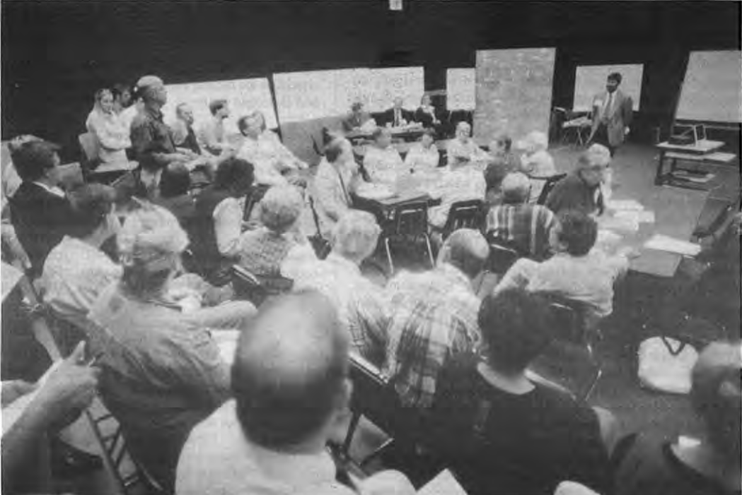 Neighbors discuss MetroLink expansion design at Crossroads School. Photographer not credited.