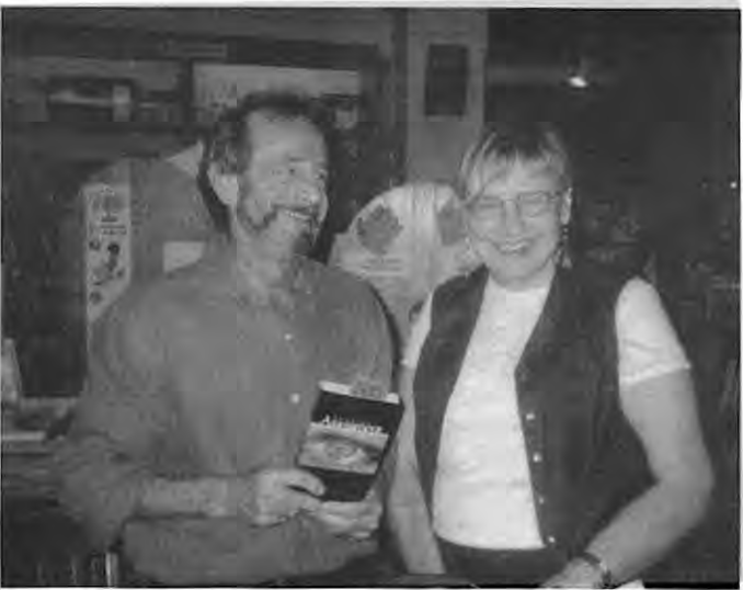 Marvin Nodiff, book in hand, with Lana Stein at Left Bank Books. Photographer not credited.