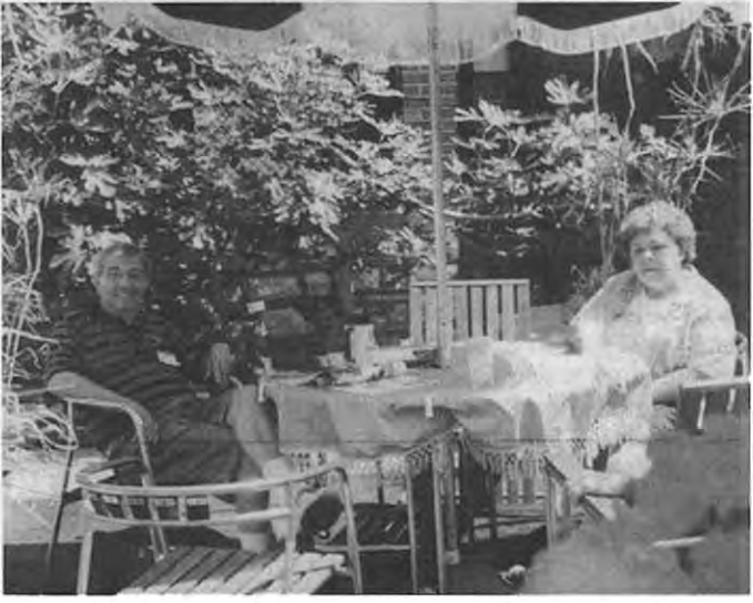 Monsignor Sal Polizzi with Peggy Droege. Photos collectively credited to Andy Cross and Dave Schmidt in November–December 2002, page 3; individual image attribution unspecified.