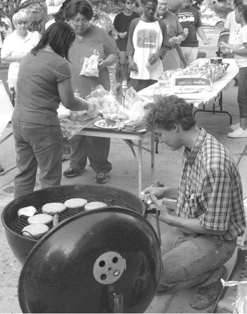Andy Cross cooks at National Night Out. Photographer not credited.