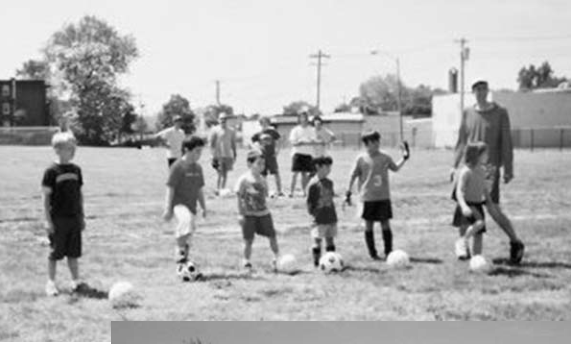 Children practice soccer at Lucier Park celebration. Photographer not credited.