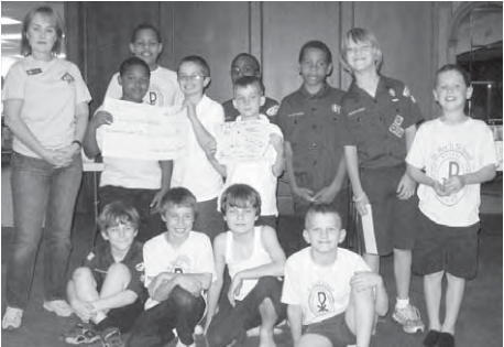 Pack 98 Cub Scouts present their donation to help save wolves. Photographer not credited.