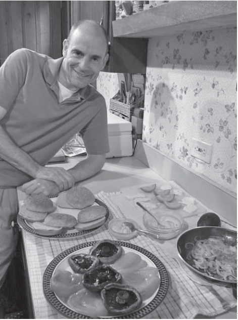 Hitch Powell prepares grilled portabello burgers during the summer.