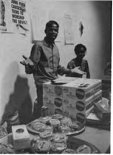 Robert Scales and Briana Taylor serving junk food at TV Eats exhibit. Photographer not credited.
