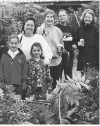 Claire, Molly and Mary Rader, Carol Brancich, Claire Kerz and Marcia Kerz clear brush along Kingsbury Square. Photographer not credited.