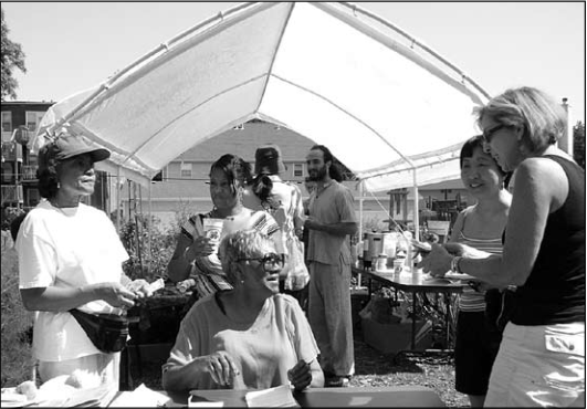 Gwen La Zard and Roni Halliburton manned the breakfast tour desk for customers Betty Burke and friends. Photographer not credited.