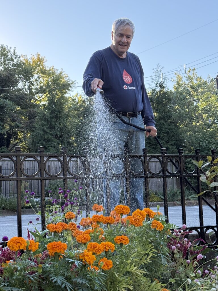 Paul Kurtz waters the Bonafide parking lot garden.