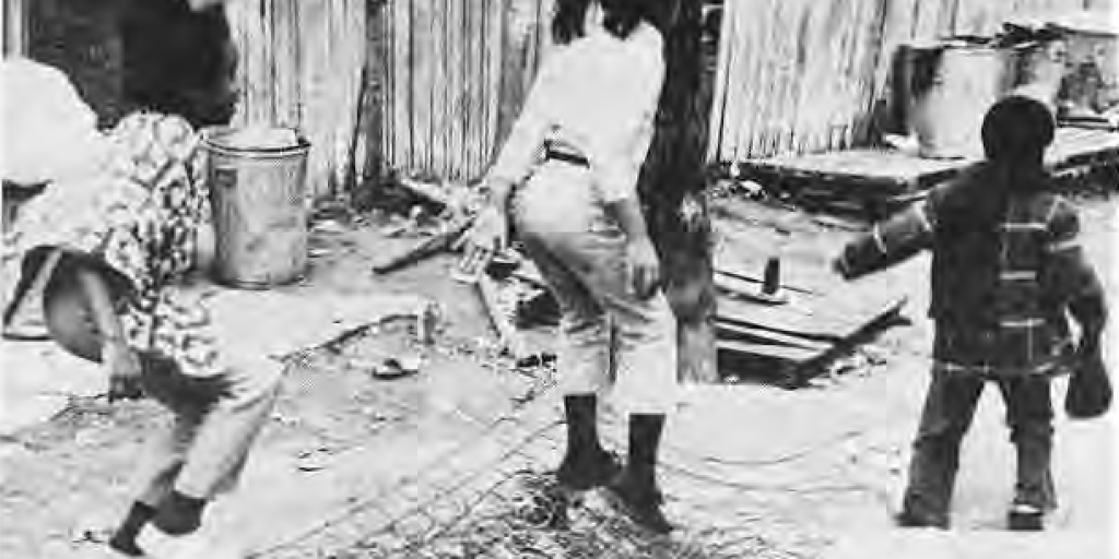 Children using discarded materials to make a trampoline, as described in the original caption.