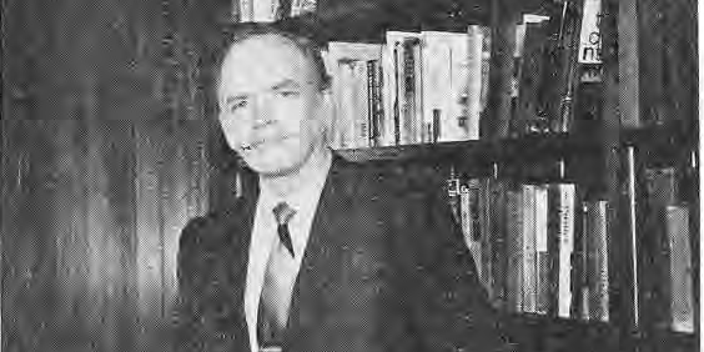Rev. Robert Gordon, identified by the printed photograph caption, seated beside bookshelves.