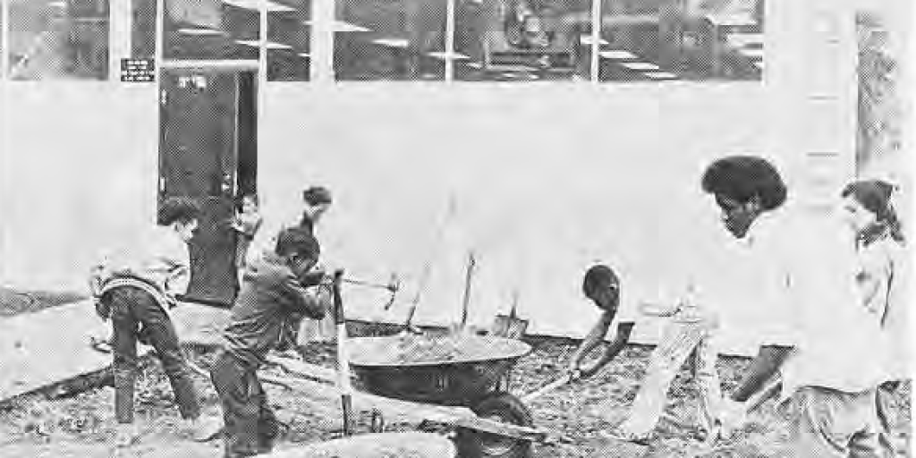 Workers making improvements outside the Des Peres Branch Library; the caption names Mrs. Smith, Betty Newsham and Dale.