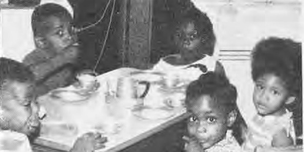 Children at a table in the Project Five Day Care Center