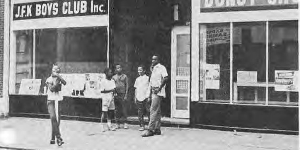 Young people outside the J.F.K. Boys Club and donut shop