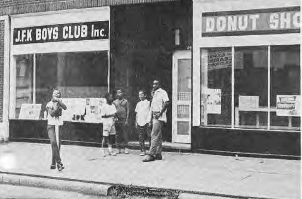 Young people outside the J.F.K. Boys Club and donut shop
