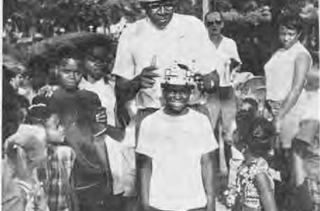 Willis Greeley, then president of the Westminster blocks places a crown on the king of the Westminster block party.
