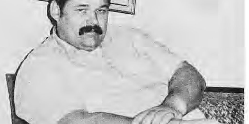 Jim L’Ecuyer seated in a chair