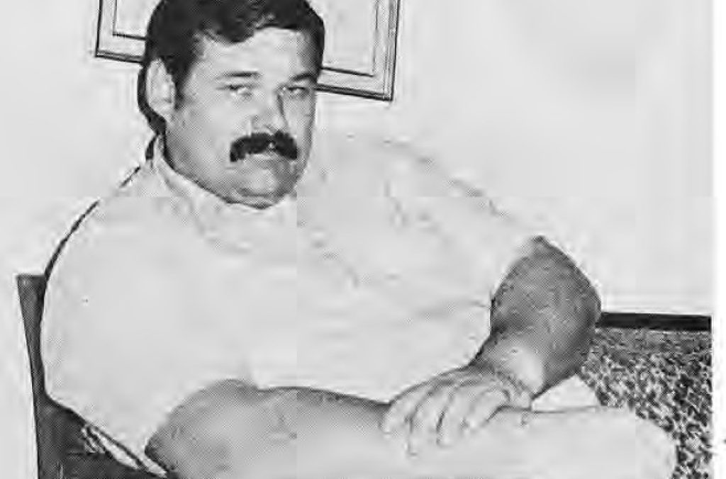 Jim L’Ecuyer seated in a chair