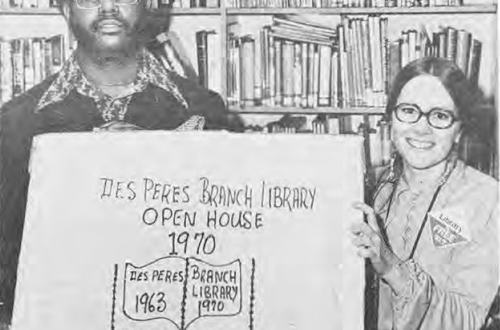 Charles Brown and Sherry Eckrich holding a library-shaped cake