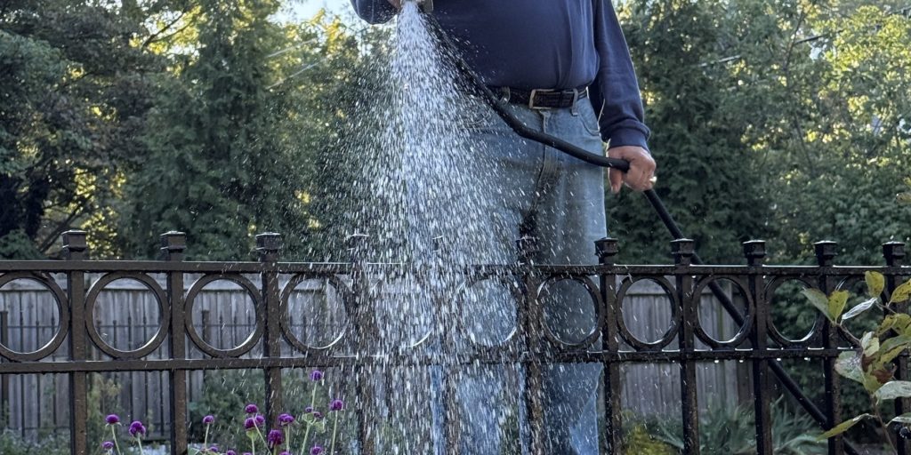 Paul Kurtz waters the Bonafide parking lot garden.
